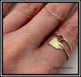 14kt yellow gold oar wrap rowing ring with rhodalite garnet by Rubini Jewelers, shown on size 7.5 index finger