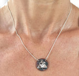 Silver Aether Symbol and Rowing Blade on Copper Disc Necklace by Rubini Jewelers, shown on woman's neck