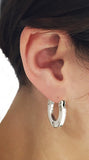 Silver Oarlock Washer Solid Hoop Earrings by Rubini Jewelers, shown on ear
