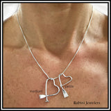 Dragon Boat, Canoe, Paddle Board, SUP Paddle Freeform Heart Pendant by Rubini Jewelers, shown on woman's neck