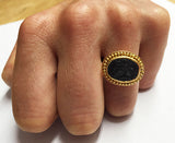 This 22k gold ring features an etching of a man on  horseback holding a banner carved into it's solo black stone. Our best guess is that it's St. George and the Dragon.  Size 7 1/4