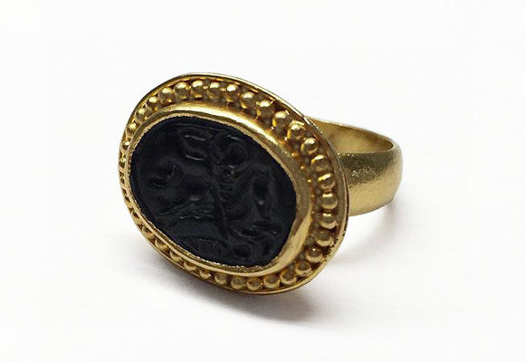 This 22k gold ring features an etching of a man on horseback holding a banner carved into it's solo black stone. Our best guess is that it's St. George and the Dragon. Size 7 1/4