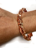 Copper Seaweed Handmade Bangle Bracelet by Rubini Jewelers, shown on wrist