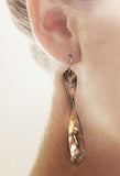 Copper Silver Twist Handmade Earrings by Rubini Jewelers, shown on ear
