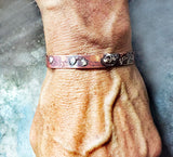 Burned Copper Silver Thin Cuff Handmade Bracelet by Rubini Jewelers, shown on man's wrist
