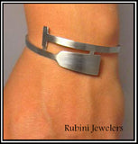Dragon Boat, SUP, Paddle Board Paddle Stainless Steel Cuff Bracelet by Rubini Jewelers, shown on woman's wrist