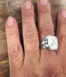 Hand Engraved Crossed Oars Signet Ring with Eagles by Rubini Jewelers, shown on man's hand