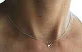 Tiny heart with hatchet oar rowing necklace sterling silver by Rubini Jewelers, shown on ladies neck