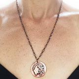 Copper Unicorn Disc with Stone on Long Chain Necklace at Rubini Jewelers, shown on neck