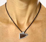 Pendant: carved leather blade bezeled in sterling silver, by Rubini Jewelers
