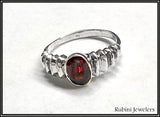 Ribbed shoulder oval garnet ring by Rubini Jewelers