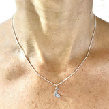 Block Letter "L" with Hatchet Blade Rowing Charm on chain, by Rubini Jewelers, shown on neck
